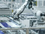 Automated Manufacturing Facility. White Industrial Robot Arm at